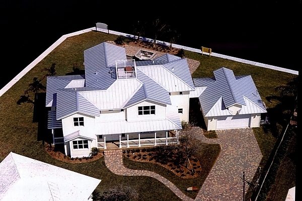 Traditional Home with siding, metal roof on pile and grade beam construction